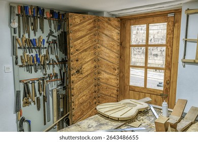Artisan flamenco guitar under construction in a traditional woodworker's studio