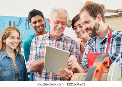 Artisan and his team using tablet for social media advertisement - Powered by Shutterstock