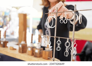 Artisan jewelry booth at a crafts fair with sterling silver accessories such as rings and earrings - Powered by Shutterstock