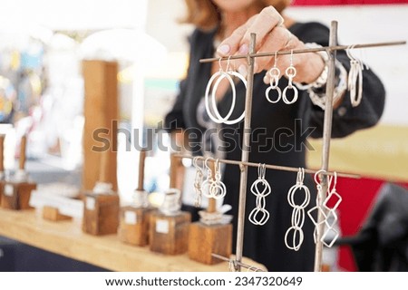 Artisan jewelry booth at a crafts fair with sterling silver accessories such as rings and earrings
