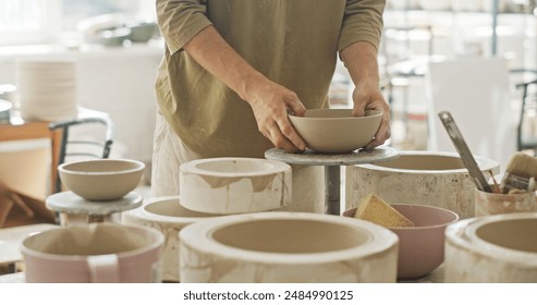 Artisan Potter Inspecting Newly Molded Ceramic Bowl in Studio - Powered by Shutterstock