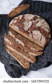 Artisan Rye Bread With Slice On A Towel. Top View, Marble Background