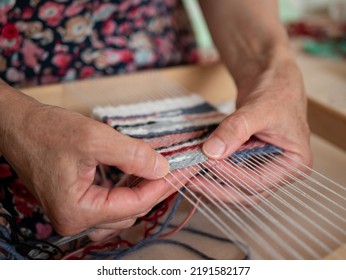 Artisan weaver is at work on the hand loom. Tapestry weaving, selective focus. Work process of artisan - Shutterstock ID 2191582177