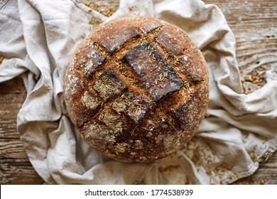 Artisan Wholemeal Sourdough Loaf Of  Bread With Addition Rosemary Herb Top  View