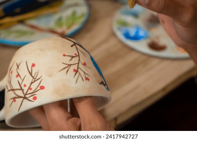 Artisan woman painting ceramics (detail) - Powered by Shutterstock