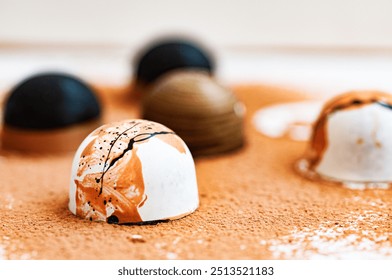 An artisanal bonbons on a cocoa-dusted surface, highlighting a white chocolate piece with bold copper and black splatters, creating a striking contrast and an elegant, gourmet feel.