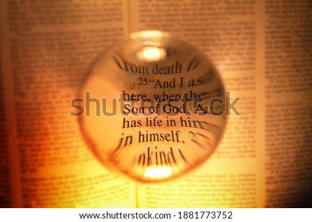 Artisic view of bible verse using a magnifying ball. Highlighting Son of God