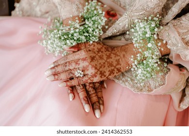 Artist applying henna tattoo on women hands. Mehndi is traditional Indian decorative art. - Powered by Shutterstock