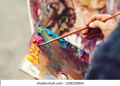Artist brush mixed color oil painting on palette. Macro artist's palette. Palette with paintbrush. Artist paints a picture of oil paints. Art palette - Shutterstock ID 1208120854