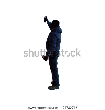 Artist with can of spray paint draws graffiti picture isolated on white background in black hood unknown back view