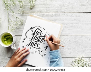An artist creating hand lettering artwork from motivation quote - Powered by Shutterstock