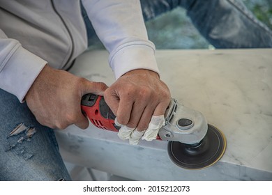 Artist cutting marble stone with angle sander and diamond disc