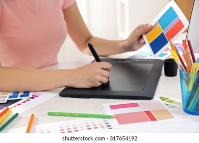Artist drawing on graphic tablet in office - Shutterstock ID 317654192