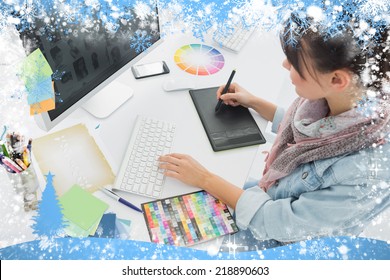 Artist drawing something on graphic tablet at office against snow - Shutterstock ID 218890603