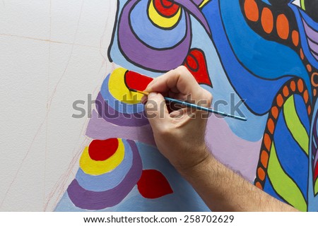 The artist draws a line in the picture.