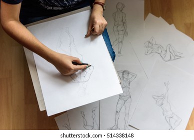 artist draws a pencil sketch on paper - Shutterstock ID 514338148