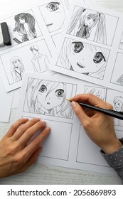 An artist draws a storyboard of an anime comics book. Manga style. - Shutterstock ID 2056869893