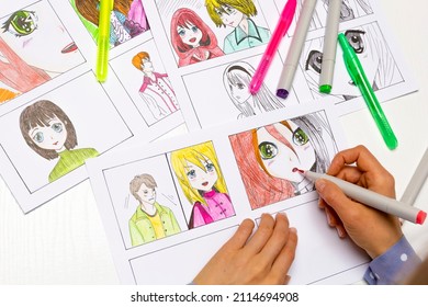 An artist draws a storyboard of an anime comics book. Manga style. The designer animator draws with a watercolor brush with a pen the characters of a color sketch of the cartoon.