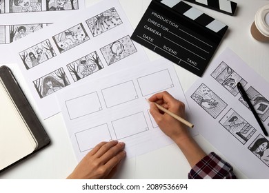 The artist draws a storyboard for the film. The director creates the storytelling by sketching footage of the script on paper. - Shutterstock ID 2089536694