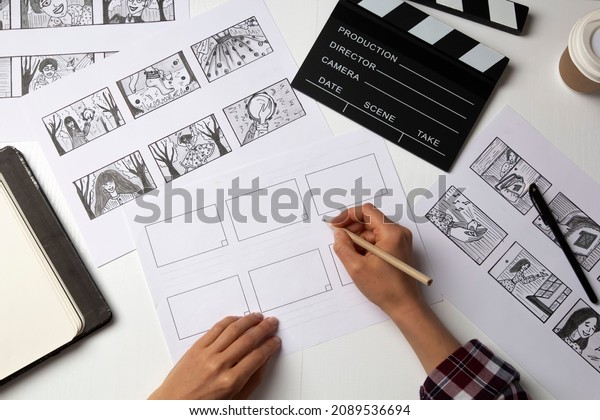The artist draws a storyboard for the film. The\
director creates the storytelling by sketching footage of the\
script on paper.