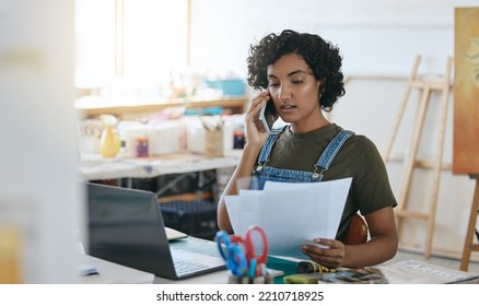 Artist, entrepreneur and phone call with budget, paper and bills with laptop in art studio. Creative startup business owner talking on mobile smartphone with mortgage, banking and rent paper at table - Powered by Shutterstock