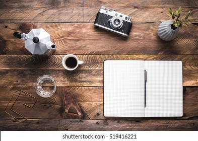 Artist, hipster, photographer table with  notebook opened, camera, coffee maker and cup of espresso. Flat lay. View from above, copy space. - Powered by Shutterstock