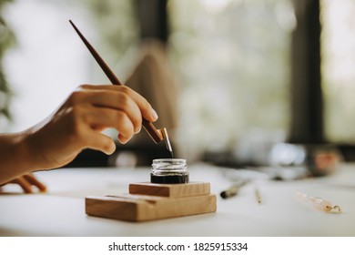 Artist Holding Old-fashioned Fountain Pen For Calligraphy Writing.