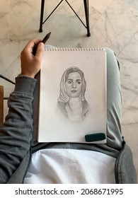 Artist Holding Sketchbook And Pencil