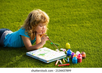 Artist Kids. Schooler Kids Drawing In Summer Park, Painting Art. Little Painter Draw Pictures Outdoor.