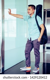 Artist Man Carrying A Guitar Case On The Shoulder In Room, Process Color.