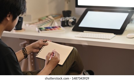 Artist Man Drawing Story Board On Paper With Pre Visualisation.