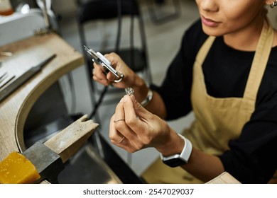 An artist meticulously shapes exquisite jewelry while surrounded by elegant tools and materials. - Powered by Shutterstock