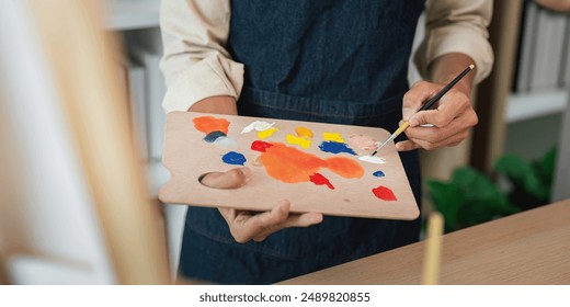 Artist Mixing Paints on Palette in Studio, Close-Up of Hands and Brush, Creative Process, Art Supplies - Powered by Shutterstock