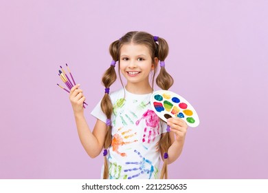 An artist on an isolated background, a little girl with paints in her hands, children's creativity. - Powered by Shutterstock