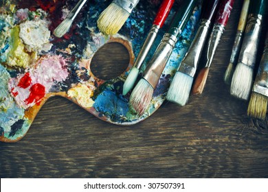 Artist Paint Brushes And Palette On Wooden Background