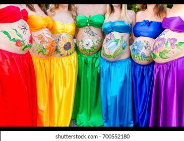 The artist painted flowers the stomachs pregnant women dressed in clothes all colors the rainbow