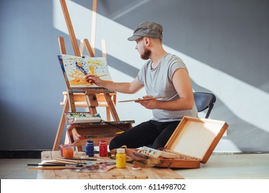 Artist Painting A Picture In A Studio.