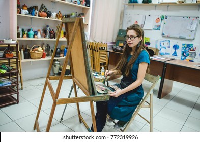 Artist painting a picture in a studio