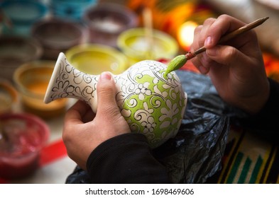 The artist paints a ceramic vase. Uzbekistan