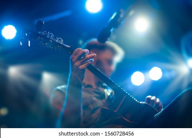 The Artist Plays The Guitar. Rock Band At A Concert