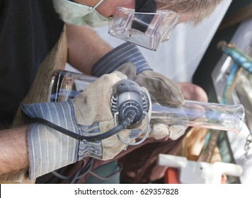 Artist Using Dremel, Etching Design On Glass.