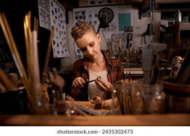 Artist, woman and tools with woodwork in workshop with craftsmanship, knife and handmade design with creativity. Wood, carpenter or creative person at workspace with equipment for handicraft or hobby - Powered by Shutterstock