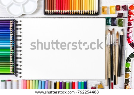 Artist workspace on white wooden background. Top view. Mock up. 