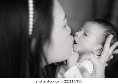 Artistic Black And White High Key Lifestyle Shot On Young And Happy Asian Chinese Woman Holding Adorable Newborn Baby Girl In Her Arms In Mother And Daughter Love Concept