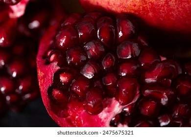 Artistic Close up Macro, Tropical open Pomegranate with seeds, also called Punica granatum. Photographed on a clean textured black background prepped ready to eat. - Powered by Shutterstock