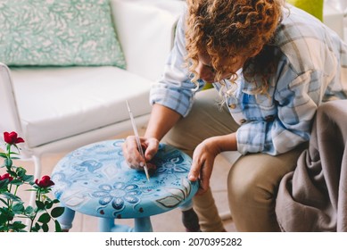 Artistic and creative woman paint at home for hobby and leisure time alone sitting on the chair. Hobby time leisure activity female people alone with colors - Powered by Shutterstock