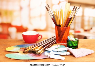 Artistic equipment: paint, brushes and art palette - Powered by Shutterstock