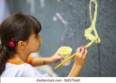 Artistic kid painting mural