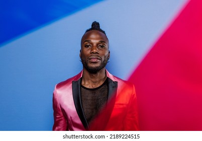 Artistic Portrait With Gel Lights. Handsome Man Posing On Colored Backgrounds