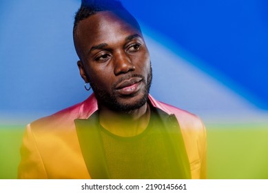 Artistic Portrait With Gel Lights. Handsome Man Posing On Colored Backgrounds